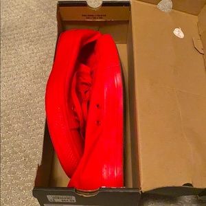 A pair of red converse sneakers